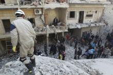 Residents search for survivors after what activists said were air strikes by forces loyal to Syria's President Bashar al-Assad in the Maysar neighbourhood of Aleppo