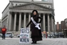 Amy Winn, 44, poses for a portrait representing 100 years of women's suffrage at the Women's Unity Rally, in front of the New York Supreme Court in Manhattan, in New York City, New York, U.S., January 19, 2019. PHOTO BY REUTERS/Gabriela Bhaskar