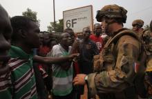 Angry young men complain to French soldiers in patrol in the pro-Christian area of Bangui, February 15, 2014. PHOTO BY REUTERS/Luc Gnago