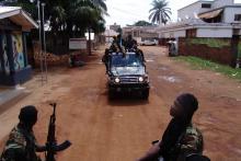 Armed fighters from the Seleka rebel alliance patrol the streets in pickup trucks