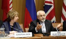 European Union Foreign Policy Chief Catherine Ashton (L) and Iranian Foreign Minister Mohammad Javad Zarif wait for the begin of talks in Vienna