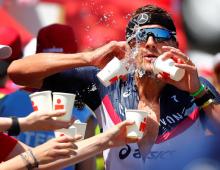 Triathlete Jan Frodeno tries to cool down as he competes in the Ironman triathlon European Championships in Frankfurt, Germany, June 30, 2019. PHOTO BY REUTERS/Kai Pfaffenbach