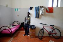 Augustine Okukpon, 17, from Nigeria poses for a photograph in his room at an immigration centre in the Sicilian town of Caltagirone, Italy, April 22, 2016. PHOTO BY REUTERS/Tony Gentile