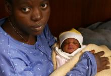 Mariam Ohene, a Nigerian migrant holds her baby girl aboard the former fishing trawler Golfo Azzurro, about thirty-two hours after her rescue along with other migrants from their drifting plastic rafts by Spanish NGO Proactiva Open Arms, in the Mediterranean Sea, off the Libyan coast April 2, 2017. PHOTO BY REUTERS/Yannis Behrakis