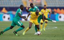 Senegal's Badou N'Diaye in action with Benin's Mickael Pote. PHOTO BY REUTERS/Mohamed Abd El Ghany