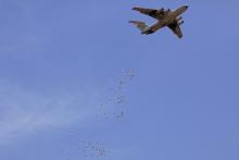 Bags of food are dropped from a plane during a WFP (World Food Program) food dropout operation in Nyal, Unity State