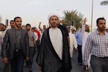 General Secretary of Al-Wefaq, Ali Salman (C), walks as protesters behind him shout anti-government slogans during a rally organized by Bahrain's main opposition party Al Wefaq in Budaiya, west of Manama