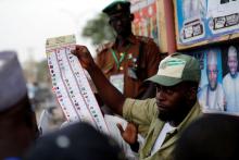 A National Youths Service Corp member counts ballot papers after voting closed at a polling station in Kano State. PHOTO BY REUTERS/Afolabi Sotunde