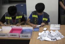 Electoral assistants count ballots at a polling station after the last day of civil referendum held by the Occupy Central organisers in Hong Kong