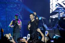 Hamed Sinno (R), lead singer of Lebanese alternative rock band Mashrou' Leila, performs during the Ehdeniyat International Festival in Ehden, Lebanon, August 12, 2017. PHOTO BY REUTERS/Jamal Saidi