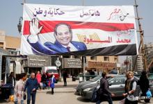 People walk by a poster of Egyptian President Abdel Fattah al-Sisi for the upcoming presidential election, in Cairo, Egypt, March 1, 2018. PHOTO BY REUTERS/Amr Abdallah Dalsh