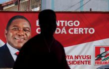 A local walks past a billboard with a picture of Mozambique's president and leader of the Frelimo Party, Filipe Nyusi, ahead of Tuesday's provincial and legislative elections, in Maputo, Mozambique, October 11, 2019. PHOTO BY REUTERS/Grant Lee Neuenburg