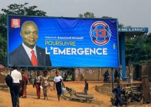 People walk past an electoral campaign billboard of Emmanuel Ramazani Shadary, former Congolese Interior Minister and presidential candidate, in Beni, North Kivu Province of Democratic Republic of Congo, December 20, 2018. PHOTO BY REUTERS/Samuel Mambo