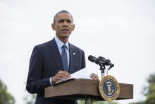 U.S. President Barack Obama speaks to reporters about new sanctions imposed on Russia as he departs the White House in Washington