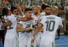 Algeria's Youcef Belaili celebrates scoring their first goal with team mates. PHOTO BY REUTERS/Sumaya Hisham