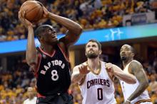 Toronto Raptors center Bismack Biyombo (8) shoots as Cleveland Cavaliers forward Kevin Love (0) defends during the first quarter in game one of the Eastern conference finals of the NBA Playoffs at Quicken Loans Arena. PHOTO BY REUTERS/Ken Blaze-USA TODAY Sports