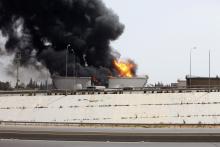 A general view shows fire burning at a fuel depot near the airport road in Tripoli