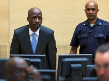 Charles Ble Goude of Ivory Coast (L) enters the courtroom of the International Criminal Court (ICC) for his initial appearance in The Hague, March 27, 2014. PHOTO BY REUTERS/Michael Kooren
