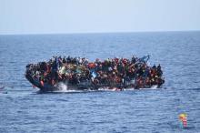 Migrants are seen on a capsizing boat before a rescue operation by Italian navy ships "Bettica" and "Bergamini" (unseen) off the coast of Libya in this handout picture released by the Italian Marina Militare, May 25, 2016. PHOTO BY REUTERS/Marina Militare