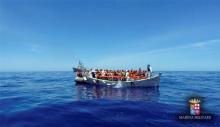 Migrants sit in their boat during a rescue operation by Italian navy ship Grecale (unseen) off the coast of Sicily, Italy, May 6 2016. PHOTO BY REUTERS/Marina Militare