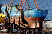 The wreck of a fishing boat that sank in April 2015, drowning hundreds of migrants packed on board, is seen after being raised in the Sicilian harbour of Augusta, Italy, July 1, 2016. PHOTO BY REUTERS/Antonio Parrinello