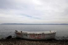 A wooden boat, used by migrants and refugees, is abandoned at a beach on the Greek island of Lesbos November, 2015. The writing on the boat reads "Aegean zero hour". PHOTO BY REUTERS/Yannis Behrakis