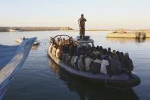 African migrants are seen seated in a boat, after being rescued by the Libyan navy. PHOTO BY REUTERS/Stringer