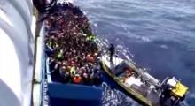 A boat full of migrants is seen next to Swedish ship Poseidon during a rescue operation in the sea off the coast of Libya in this still image taken from an August 26, 2015 video. PHOTO BY REUTERS/Swedish Coast Guard Handout via Reuters TV