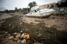 A washed up boat lies amongst storm debris on Wimbe beach as the region braces for further rainfall in the aftermath of Cyclone Kenneth, in Pemba, Mozambique, April 27, 2019. PHOTO BY REUTERS/Mike Hutchings