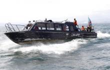 Congolese soldiers use their boat to search for passengers of a boat that capsized in Lake Kivu near Goma in eastern Democratic Republic of Congo, May 6, 2014. PHOTO BY REUTERS/Kenny Katombe