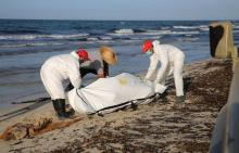 Libyan Red Crescent workers put bodies into body bags, after migrants who died when a boat sank off the coastal town of Zuwara west of Tripoli, in Libya, June 3, 2016. PHOTO BY REUTERS/Hani Amara