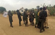 Boko Haram militants (in camouflage) embrace and shake hands with Boko Haram prisoners, released in exchange for a group of 82 Chibok girls, who were held captive for three years by Islamist militants, near Kumshe, Nigeria, May 6, 2017. PHOTO BY REUTERS/Zanah Mustapha