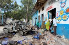 Residents gather at the scene of a suicide car bomb explosion, at the gate of Naso Hablod Two Hotel in Hamarweyne district of Mogadishu, Somalia, October 29, 2017. PHOTO BY REUTERS/Feisal Omar