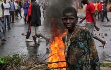 A protester poses for a photograph as they barricade a road to demonstrate against plans by Burundian President Pierre Nkurunziza to run for a third five-year term in office, in Bujumbura, May 8, 2015. PHOTO BY REUTERS/Jean Pierre Aime Harerimana