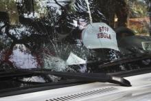 The broken windshield of an Ebola emergency team vehicle is seen after it had been pelted with stones in Lola, February 9, 2015. PHOTO BY REUTERS/Misha Hussain