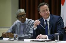 Nigeria's President Muhammadu Buhari (L) and Britain's Prime Minister David Cameron (R) look on during a breakfast dialogue with Youth Leaders at the Commonwealth Heads of Government Meeting (CHOGM) in Valletta, Malta, November 28, 2015. PHOTO BY REUTERS/Andrew Winning