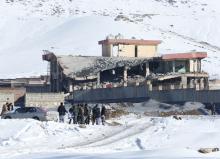 Afghan men stand in front of a collapsed building of a military base after a car bomb attack in Maidan Wardak, Afghanistan, January 21, 2019. PHOTO BY REUTERS/Stringer