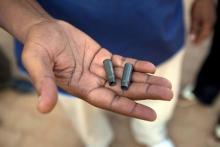 A man holds bullet cases in a ile photo. PHOTO BY REUTERS/Joe Penney