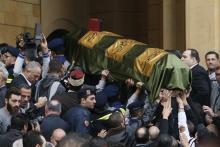 People carry the coffin of former Lebanese minister Mohamad Chatah's bodyguard Tarek Badr, who was killed in a bomb blast on Friday, during his mass funeral at al-Amin mosque in Martyrs' Square in downtown Beirut