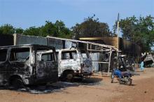 Burnt vehicles and houses are pictured on a street, after Boko Haram militants raided the town of Benisheik