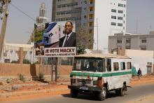 A bus drives past a campaign poster for the upcoming presidential election, depicting Senegal's president Macky Sall and wording that reads "I vote Macky Sall because he brought about the TER", in Dakar, Senegal, February 12, 2019. PHOTO BY REUTERS/Zohra Bensemra 