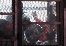 The accused are seen in a metal cage during a trial of 200 people charged with belonging to the Ansar Bait al-Maqdis group, in a court in Cairo March 5, 2015. PHOTO BY REUTERS/Al Youm Al Saabi Newspaper