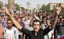 Cairo university students and members of the Muslim Brotherhood shout slogans against the military in front of Cairo University in Cairo