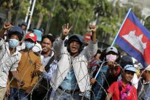 Protesters shout near the Council of Ministers building during a demonstration in central Phnom Penh