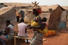 A woman carries her child in a camp sheltering internally displaced people (IDPs) next to the M'Poko international airport in Bangui, Central African Republic, February 13, 2016. PHOTO BY REUTERS/Siegfried Modola