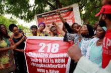 Members of the #BringBackOurGirls (#BBOG) campaign stand behind a banner with Number 218 during a sit-out in Abuja, Nigeria May 18, 2016, after receiving news that a Nigerian teenager kidnapped by Boko Haram from her school in Chibok more than two years ago has been rescued. PHOTO BY REUTERS/Afolabi Sotunde