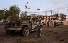 The wreckage of an unidentified car destroyed in an explosion is seen as Somali security officers secure the scene of a suicide car explosion in front of the national theater in Somalia's capital Mogadishu, March 21, 2017. PHOTO BY  REUTERS/Feisal Omar