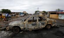 The wreckage of a car burnt during recent clashes between protesters and riot police is used to block a main street in Burundi's capital Bujumbura, May 2, 2015. PHOTO BY REUTERS/Thomas Mukoya