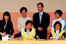 Carrie Lam (2nd L) smiles as officials count votes during the election for Hong Kong's next Chief Executive in Hong Kong, China, March 26, 2017. PHOTO BY REUTERS/Bobby Yip