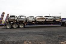 Burned vehicles are piled onto a truck after a fire accident involving an oil tanker along the Lagos-Ibadan expressway in the Ojodu axis of Lagos, Nigeria, June 29, 2018. PHOTO BY REUTERS/Akintunde Akinleye